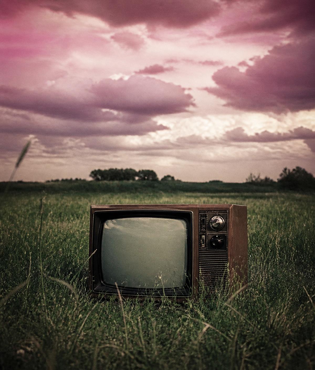 Televisão vintage num campo aberto